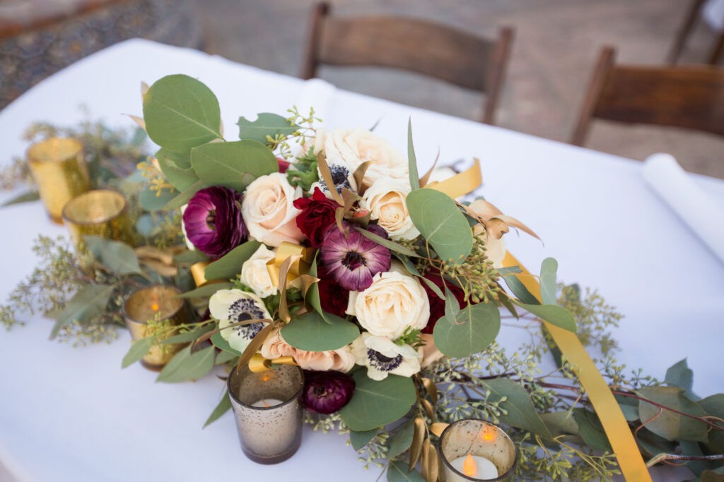 Wedding floral centerpiece with rose gold and greenery