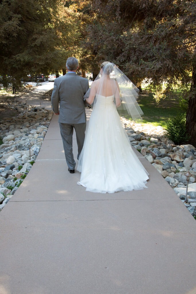 Ceremony procesional of los angeles bride walking with father