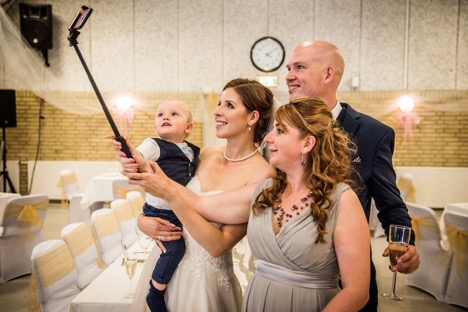 Bridesmaid bride groom and ring bearer taking selfie