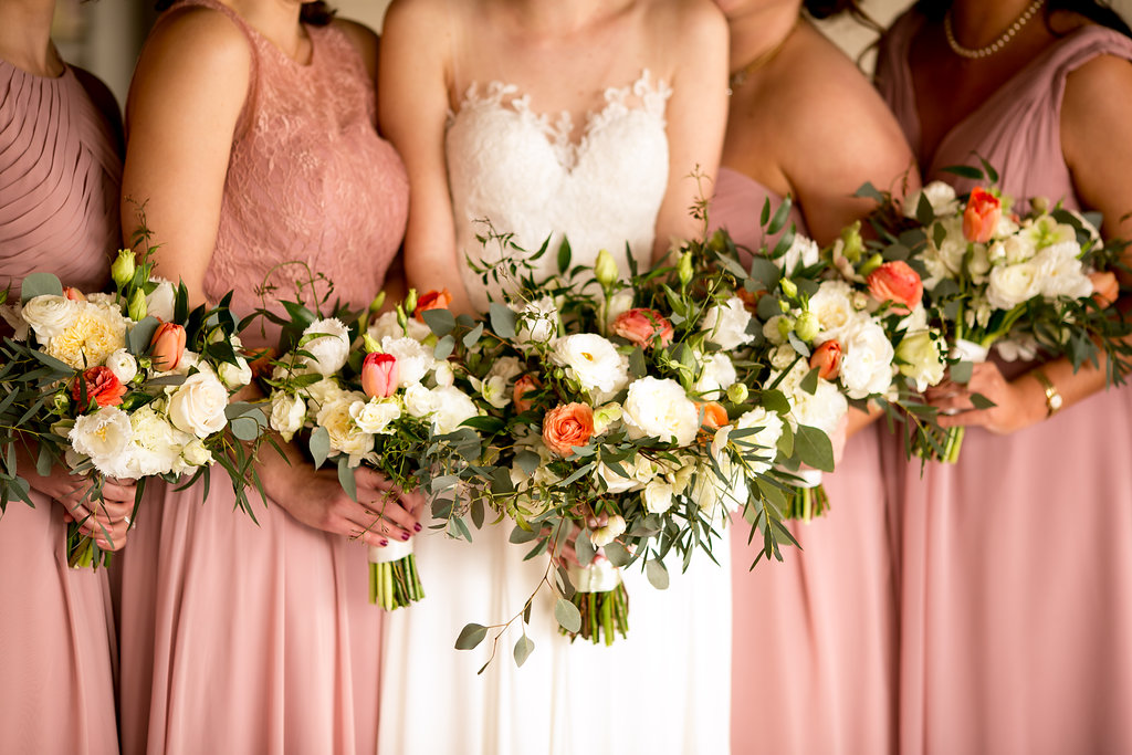 Bridesmaids and bride in blush dresses and rustic bouquets